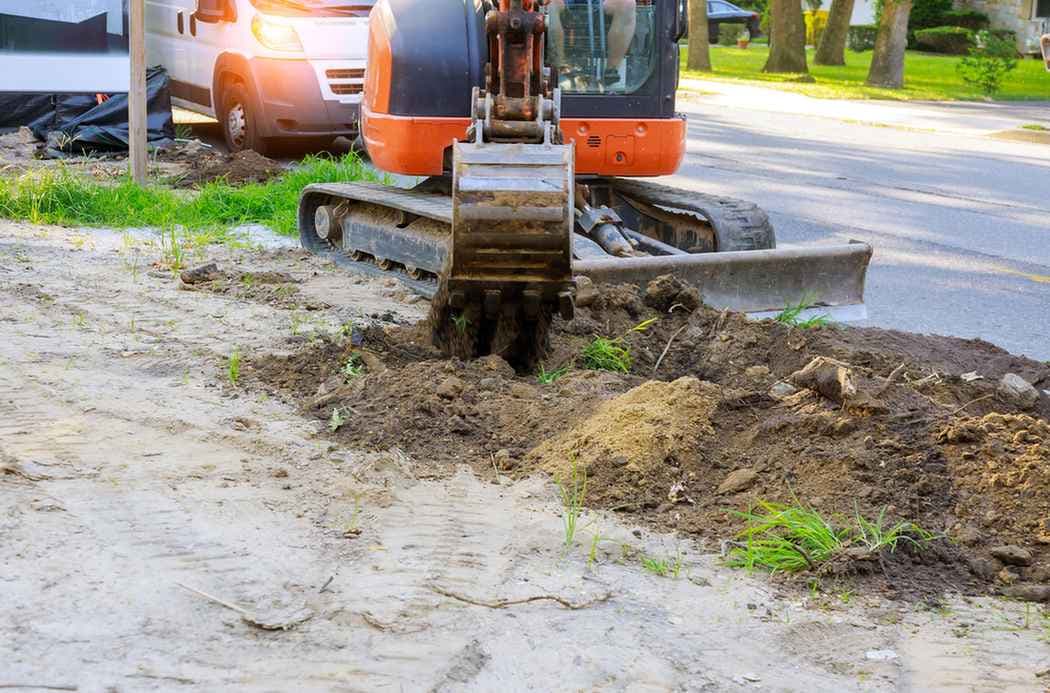 Excavator digging hole