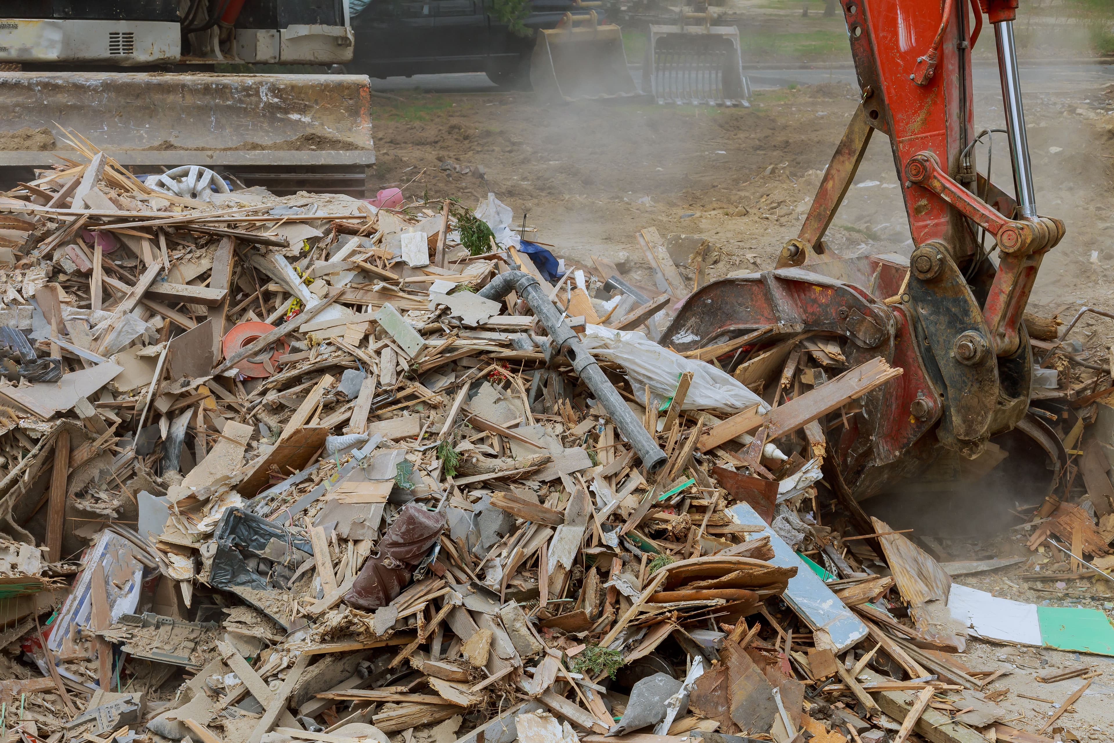Bulldozer arm scooping rubble