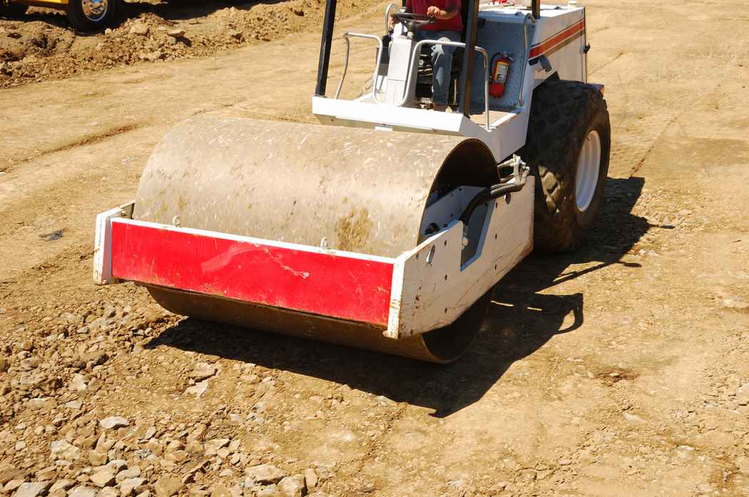 Roller flattening dirt and rocks